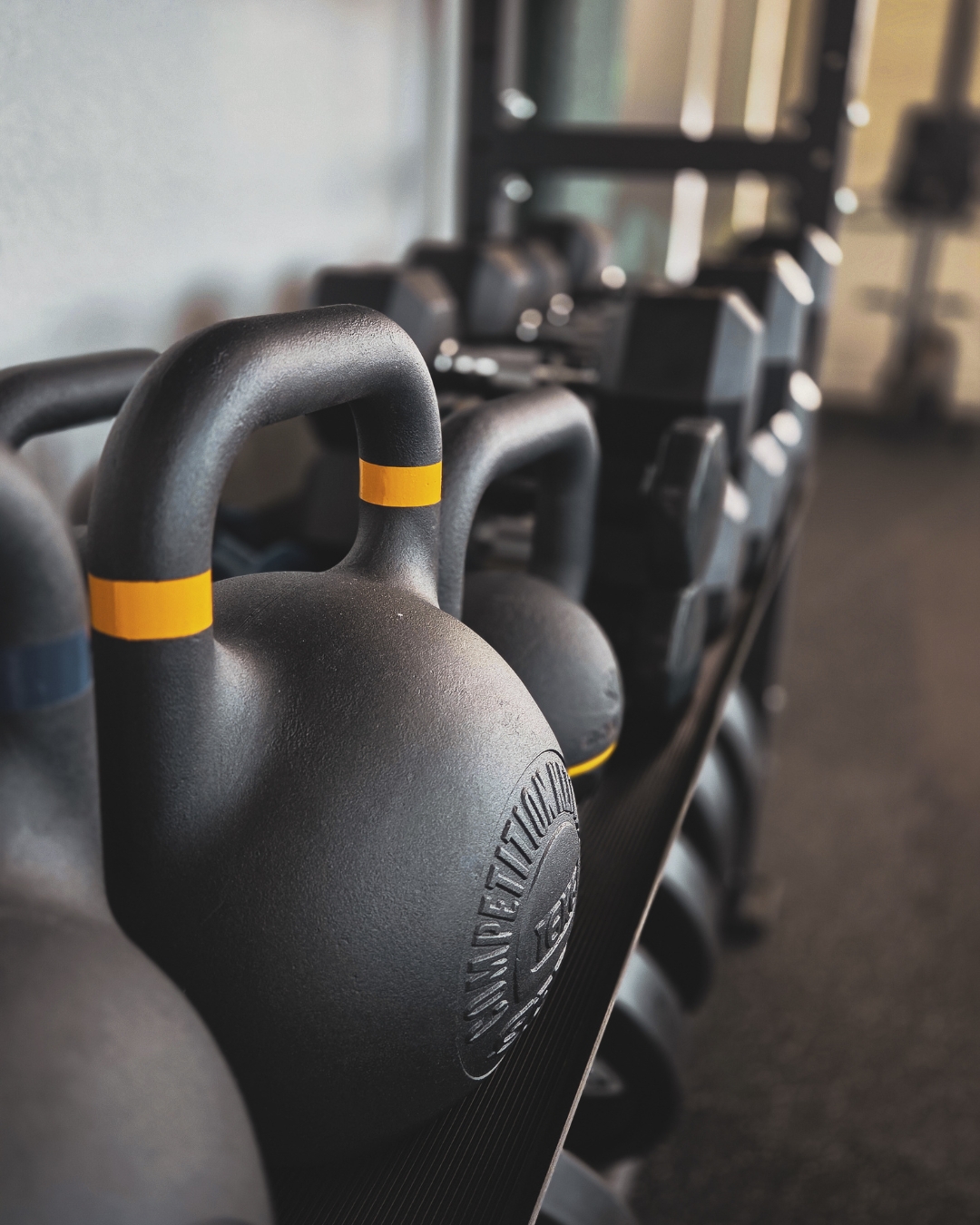 Functional training : se dépasser avec simplicité Kettlebells alignés dans une salle de sport, matériel utilisé en functional training chez Joy N Sport